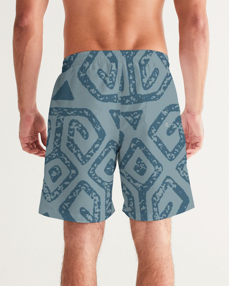 Men's Teal Tribal Cloth Swim Trunks — bold all-over print by AmbiVirile, detail view