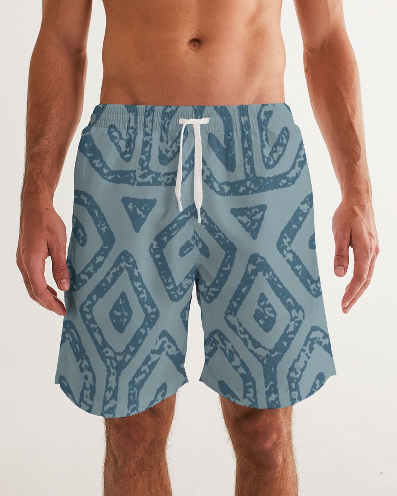 Men's Teal Tribal Cloth Swim Trunks — bold all-over print by AmbiVirile, front view