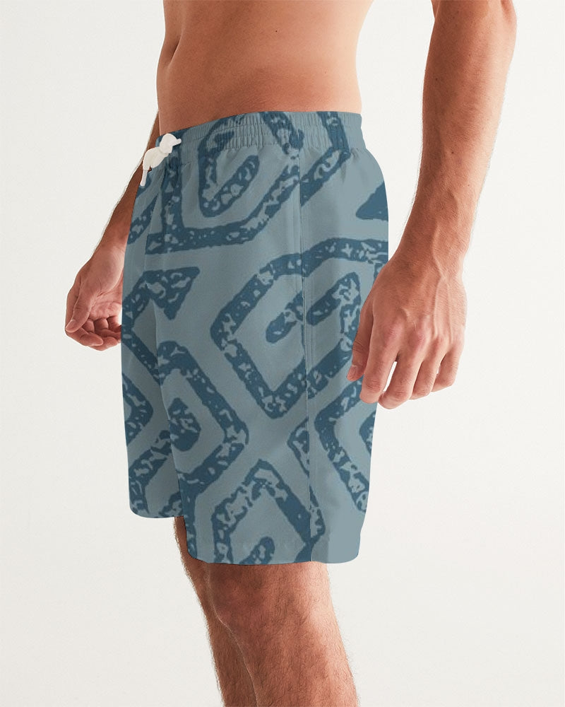Men's Teal Tribal Cloth Swim Trunks — bold all-over print by AmbiVirile, side view